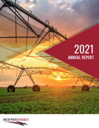 2021 Annual Report cover for High West Energy, featuring a sunset over a field with an irrigation system and the company logo.