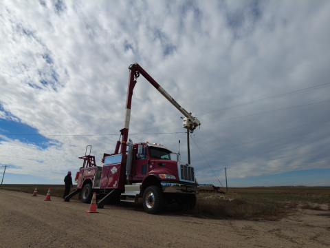 HWE truck on the side of the road fixing the insulator. 